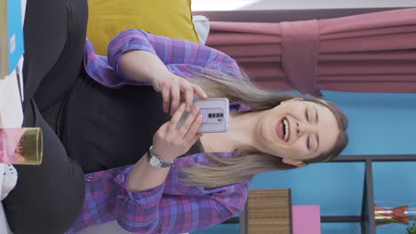 Vertical-video-of-Woman-smiling-at-phone-message.